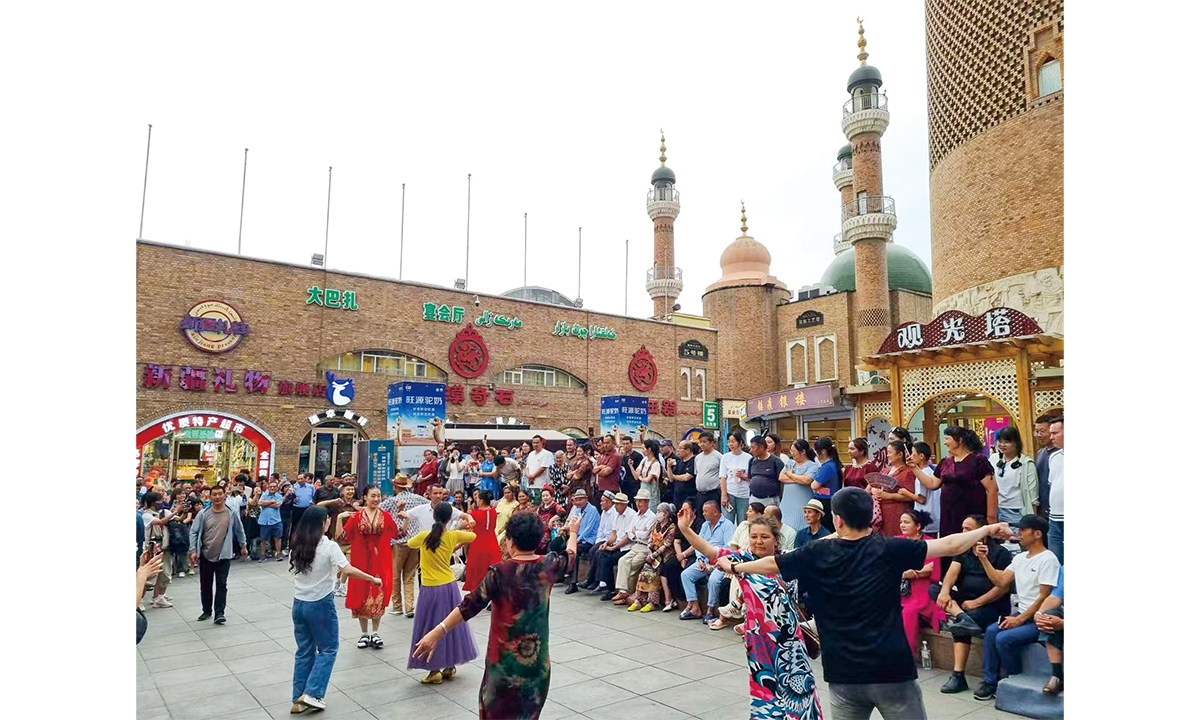 Residents dance in the Grand Bazaar, Urumqi, capital city of Xinjiang Uygur Autonomous Region. Photos: Hilton Yip