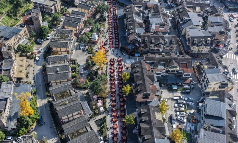 An aerial drone photo taken on Nov. 20, 2025 shows residents attending a group banquet in celebration of the Qiang New Year in Wenchuan County, Aba Tibetan and Qiang Autonomous Prefecture, southwest China's Sichuan Province. An event celebrating the Qiang New Year was held here from Wednesday to Thursday, featuring a series of activities. (Photo by Li Xiangyu/Xinhua)