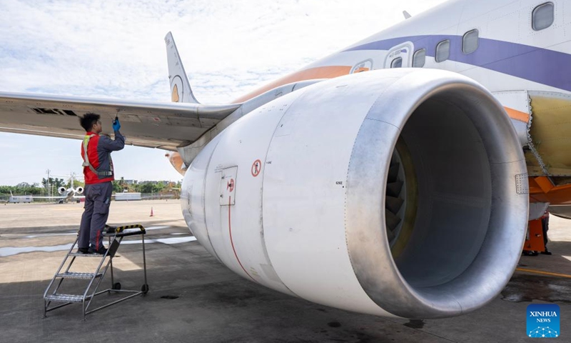 Staff members of the Grand China Aviation Maintenance Co., Ltd. under the HNA Technic perform maintenance on an aircraft at the Hainan Free Trade Port (FTP) One-Stop Aircraft Maintenance Base in Haikou, south China's Hainan Province, on Nov. 21, 2025. The Hainan Free Trade Port (FTP) One-Stop Aircraft Maintenance Base, which started operation in 2022, has performed maintenance service on more than 2,400 aircraft, completed full-body painting for over 280 aircraft, and repaired about 60,000 aircraft components as of the end of October this year.
The maintenance base has drawn global clients like Qatar Airways, Royal Air Philippines and Iberia.
Under the Hainan FTP's favorable regulations, aircraft entering the region for maintenance are exempt from paying security deposits, and parts imported for repair benefit from a bonded status. The policy support is expected to be amplified following the FTP's official launch of island-wide independent customs operations on Dec. 18. Photo: Xinhua