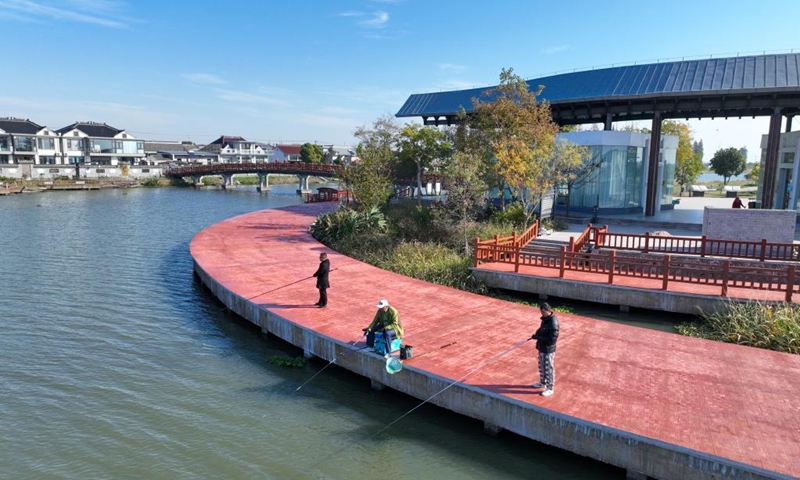 An aerial drone photo taken on Nov. 21, 2025 shows villagers fishing by a river in Liuze Village of Xinghua, east China's Jiangsu Province. Local authorities in Xinghua have sought to embed environmental construction into the rural industry landscape in recent years, helping create numerous villages that are both livable and suitable for business operations. Photo: Xinhua