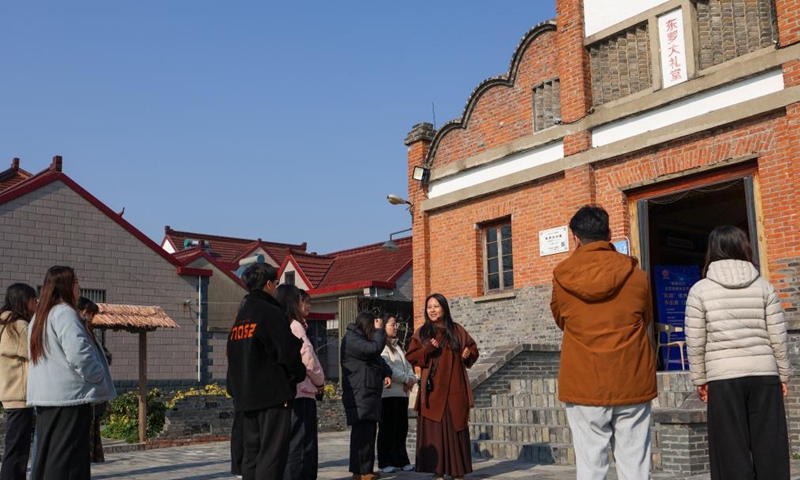 Tourists visit the Dongluo Village, which has been listed in the UN Tourism's 2025 edition of Best Tourism Villages, with a local tour guide (3rd R) in Xinghua, east China's Jiangsu Province, Nov. 21, 2025. Local authorities in Xinghua have sought to embed environmental construction into the rural industry landscape in recent years, helping create numerous villages that are both livable and suitable for business operations. Photo: Xinhua