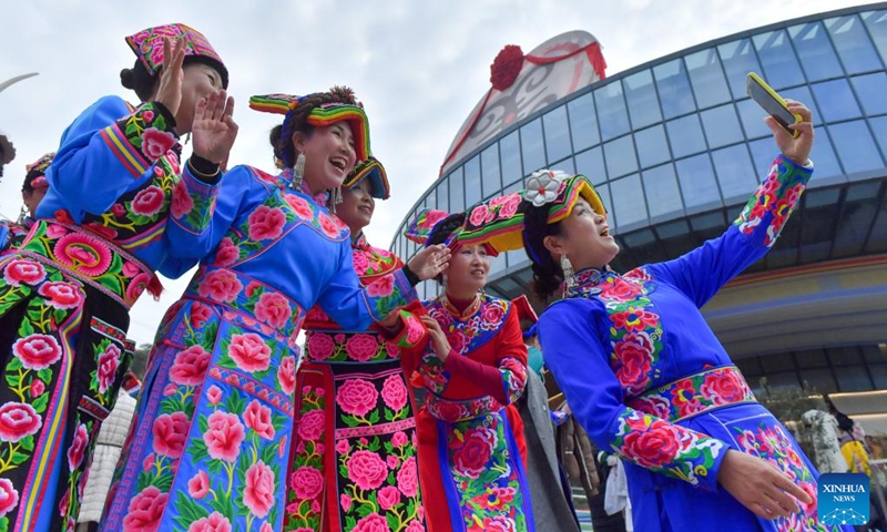 Women in ethnic attire take a selfie during an event celebrating the Qiang New Year in Wenchuan County, Aba Tibetan and Qiang Autonomous Prefecture, southwest China's Sichuan Province, Nov. 20, 2025. An event celebrating the Qiang New Year was held here from Wednesday to Thursday, featuring a series of activities. (Photo by Li Xiangyu/Xinhua)