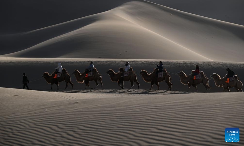 Tourists visit the Mingsha Mountain and Crescent Spring Scenic Area in Dunhuang City, northwest China's Gansu Province, on Nov. 22, 2025. Photo: Xinhua