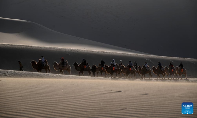 Tourists visit the Mingsha Mountain and Crescent Spring Scenic Area in Dunhuang City, northwest China's Gansu Province, on Nov. 22, 2025. Photo: Xinhua