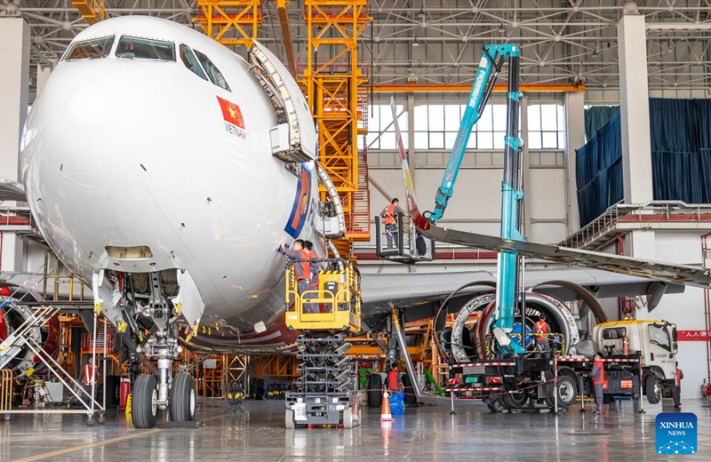 Staff members of the Grand China Aviation Maintenance Co., Ltd. under the HNA Technic perform maintenance on an aircraft at the Hainan Free Trade Port (FTP) One-Stop Aircraft Maintenance Base in Haikou, south China's Hainan Province, on Nov. 21, 2025. The Hainan Free Trade Port (FTP) One-Stop Aircraft Maintenance Base, which started operation in 2022, has performed maintenance service on more than 2,400 aircraft, completed full-body painting for over 280 aircraft, and repaired about 60,000 aircraft components as of the end of October this year.
The maintenance base has drawn global clients like Qatar Airways, Royal Air Philippines and Iberia.
Under the Hainan FTP's favorable regulations, aircraft entering the region for maintenance are exempt from paying security deposits, and parts imported for repair benefit from a bonded status. The policy support is expected to be amplified following the FTP's official launch of island-wide independent customs operations on Dec. 18. Photo: Xinhua