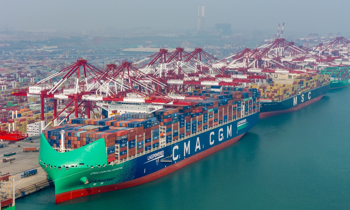 Three containerships berth at Port of Qingdao, East China's Shandong Province to handle cargo on November 23, 2025. Container throughput at the major shipping hub in East China in the first nine months totaled 25.84 million 20-foot equivalent units, up 7.1 percent year-on-year, according to a stock exchange filing by the port. Photo: VCG