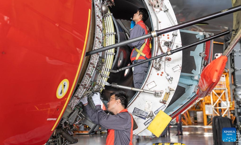 Staff members of the Grand China Aviation Maintenance Co., Ltd. under the HNA Technic perform maintenance on an aircraft at the Hainan Free Trade Port (FTP) One-Stop Aircraft Maintenance Base in Haikou, south China's Hainan Province, on Nov. 21, 2025. The Hainan Free Trade Port (FTP) One-Stop Aircraft Maintenance Base, which started operation in 2022, has performed maintenance service on more than 2,400 aircraft, completed full-body painting for over 280 aircraft, and repaired about 60,000 aircraft components as of the end of October this year.
The maintenance base has drawn global clients like Qatar Airways, Royal Air Philippines and Iberia.
Under the Hainan FTP's favorable regulations, aircraft entering the region for maintenance are exempt from paying security deposits, and parts imported for repair benefit from a bonded status. The policy support is expected to be amplified following the FTP's official launch of island-wide independent customs operations on Dec. 18. Photo: Xinhua