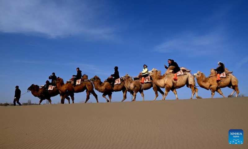 Tourists visit the Mingsha Mountain and Crescent Spring Scenic Area in Dunhuang City, northwest China's Gansu Province, on Nov. 22, 2025. Photo: Xinhua