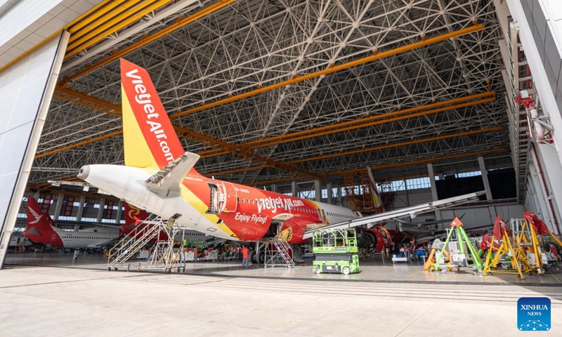 Staff members of the Grand China Aviation Maintenance Co., Ltd. under the HNA Technic perform maintenance on an aircraft at the Hainan Free Trade Port (FTP) One-Stop Aircraft Maintenance Base in Haikou, south China's Hainan Province, on Nov. 21, 2025. The Hainan Free Trade Port (FTP) One-Stop Aircraft Maintenance Base, which started operation in 2022, has performed maintenance service on more than 2,400 aircraft, completed full-body painting for over 280 aircraft, and repaired about 60,000 aircraft components as of the end of October this year.
The maintenance base has drawn global clients like Qatar Airways, Royal Air Philippines and Iberia.
Under the Hainan FTP's favorable regulations, aircraft entering the region for maintenance are exempt from paying security deposits, and parts imported for repair benefit from a bonded status. The policy support is expected to be amplified following the FTP's official launch of island-wide independent customs operations on Dec. 18. Photo: Xinhua