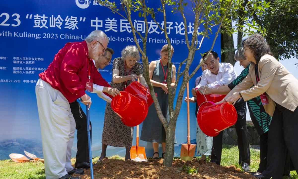 Representatives from China and the US plant trees together in Kuliang on June 28, 2023. Photo: Courtesy of People's Daily Digital Communication Co., Ltd.