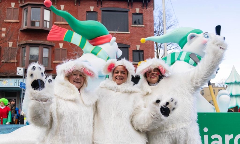 Dressed-up paraders pose for photos during the 2025 Original Santa Claus Parade in Toronto, Canada, on Nov. 23, 2025. Featuring dozens of themed floats and marching bands, the annual parade was held here on Sunday. (Photo by Zou Zheng/Xinhua)