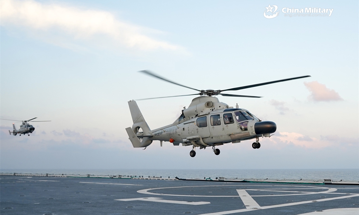 Z-9D ship-borne helicopters attached to a naval frigate flotilla under the Chinese PLA Eastern Theater Command lift off from the amphibious assault ship Anhui (Hull 33) during a take-off and landing training exercise. (eng.chinamil.com.cn/Photo by Tang Haoran)