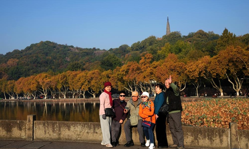 Tourists pose for photos at the West Lake scenic area in Hangzhou, east China's Zhejiang Province, Nov. 23, 2025.

The weather in Hangzhou has been fine in recent days. Many tourists get up early in the morning to visit West Lake and enjoy the beautiful winter scenery here. Photo: Xinhua