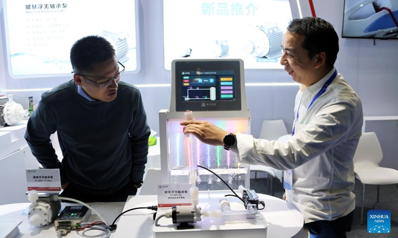 An exhibitor demonstrates the working principle of the maglev bearingless pump during the 22nd China International Semiconductor Expo in Beijing, capital of China, Nov. 23, 2025. The expo opened here on Sunday. (Xinhua/Pan Xu)