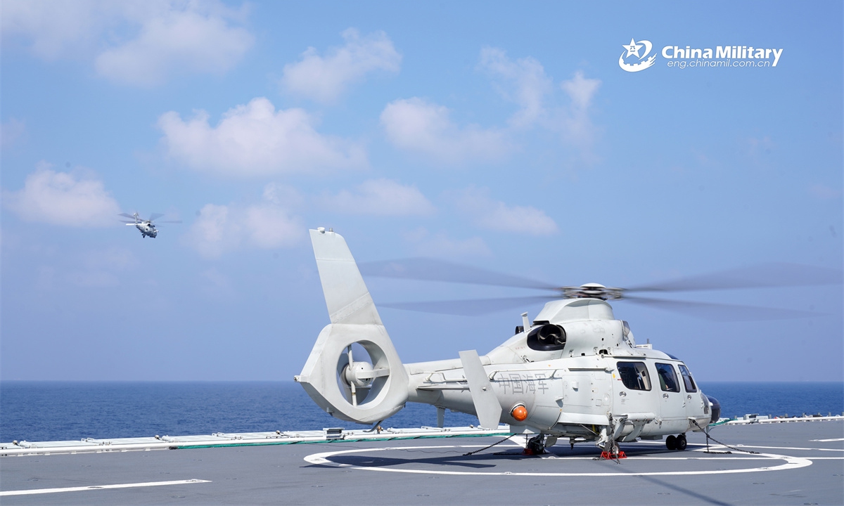 A Z-9D ship-borne helicopter attached to a naval frigate flotilla under the Chinese PLA Eastern Theater Command lands on the deck of the amphibious assault ship Anhui (Hull 33) during a take-off and landing training exercise. (eng.chinamil.com.cn/Photo by Tang Haoran)