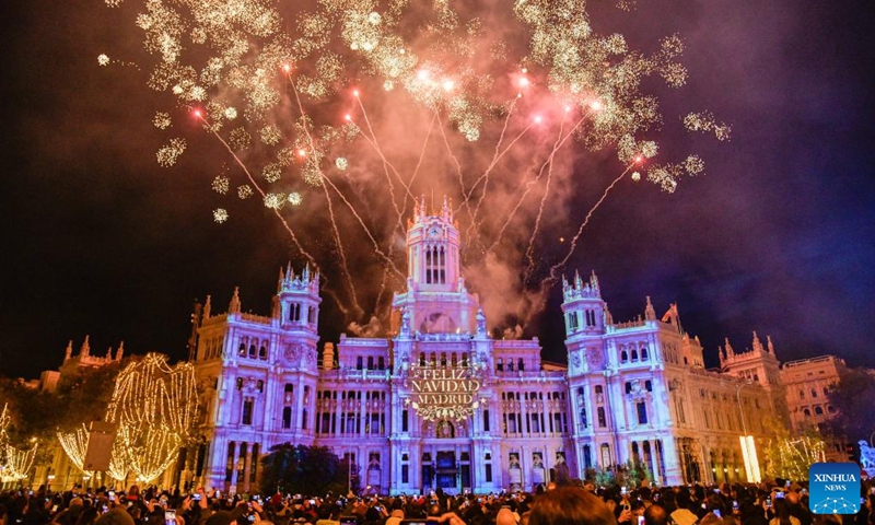 People enjoy a projection light show in front of the Cibeles Palace in Madrid, Spain, Nov. 22, 2025. Madrid held a Christmas light-up ceremony on Saturday with a projection light show. (Xinhua/Cheng Min)