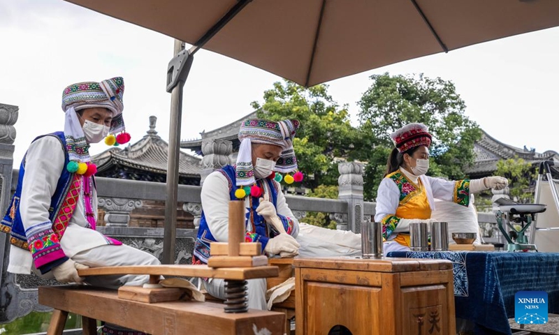 Staff members demonstrate the making process of Tuocha during a promotion week for intangible cultural heritage brands in Dali, southwest China's Yunnan Province, Nov. 23, 2025. More than 120 brands of intangible cultural heritage took part in the brand promotion week which opened here on Sunday. Photo: Xinhua