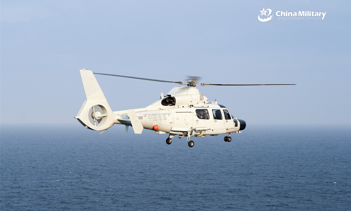 A Z-9D ship-borne helicopter attached to a naval frigate flotilla under the Chinese PLA Eastern Theater Command searches the designated sea area during a take-off and landing training exercise. (eng.chinamil.com.cn/Photo by Tang Haoran)