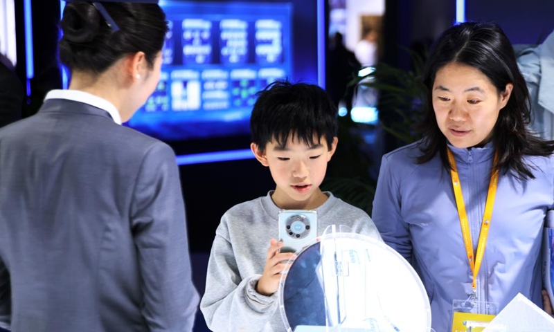 A child visits the 22nd China International Semiconductor Expo in Beijing, capital of China, Nov. 23, 2025. The expo opened here on Sunday. (Xinhua/Pan Xu)