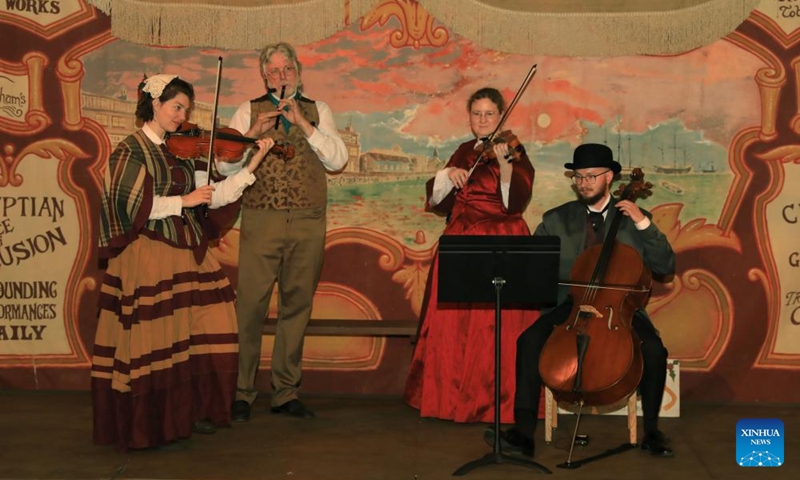 People wearing costumes of the Victorian era perform during the Great Dickens Christmas Fair in San Francisco, the United States, Nov. 22, 2025.

The Great Dickens Christmas Fair, which was first held in 1970, opened here on Saturday. Featuring an immersive adventure into Victorian era, the fair transports visitors in a world created by British novelist Charles Dickens in a festive mood. Photo: Xinhua