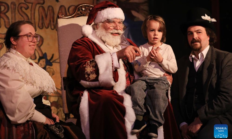 Actors dressed as Santa Claus (2nd L) and Mrs. Claus (1st L) pose for photos with a man and his daughter during the Great Dickens Christmas Fair in San Francisco, the United States, Nov. 22, 2025.

The Great Dickens Christmas Fair, which was first held in 1970, opened here on Saturday. Featuring an immersive adventure into Victorian era, the fair transports visitors in a world created by British novelist Charles Dickens in a festive mood. Photo: Xinhua