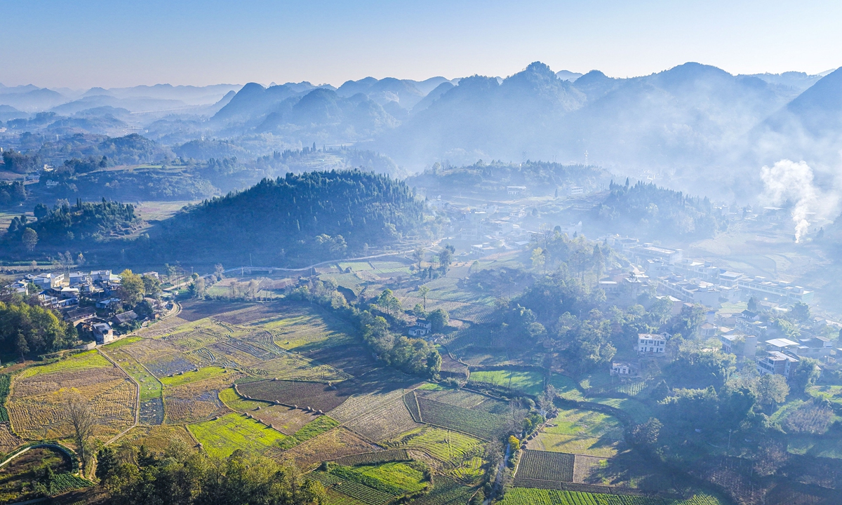 Mist curls around the mountains in Qianxi of Southwest China's Guizhou Province, weaving together villages, emerald peaks, and patchwork fields into a breathtaking scene on November 24, 2025. Photo: VCG