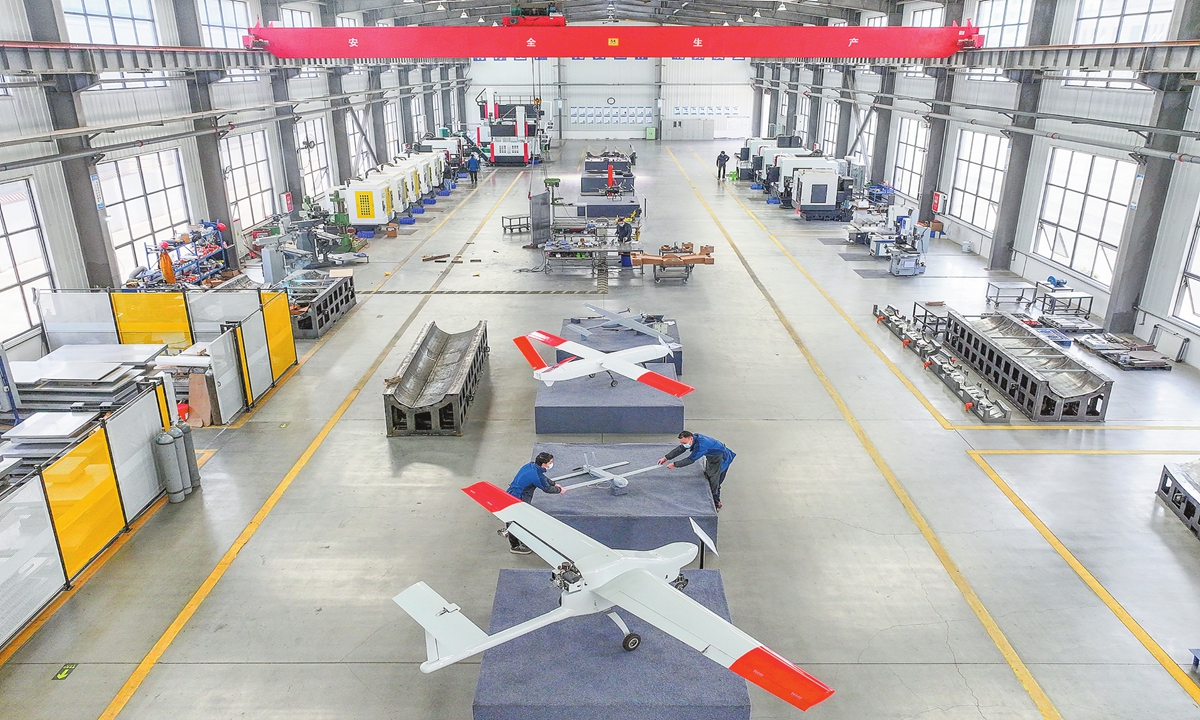 Employees work on the assembly line at Lingshenhang New Material Technology Co in the Huayingshan Economic Development Zone, Huaying, Southwest China's Sichuan Province, on November 25, 2025. Founded in 2021, the company specializes in manufacturing auto parts and drones. It currently operates one specialized mold production line for drones and three fiber product lines. Photo: VCG