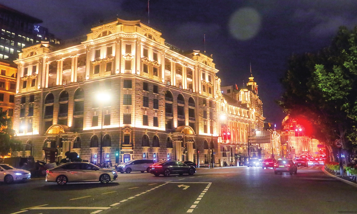 Cars pass by the Bund architectural complex in Shanghai.