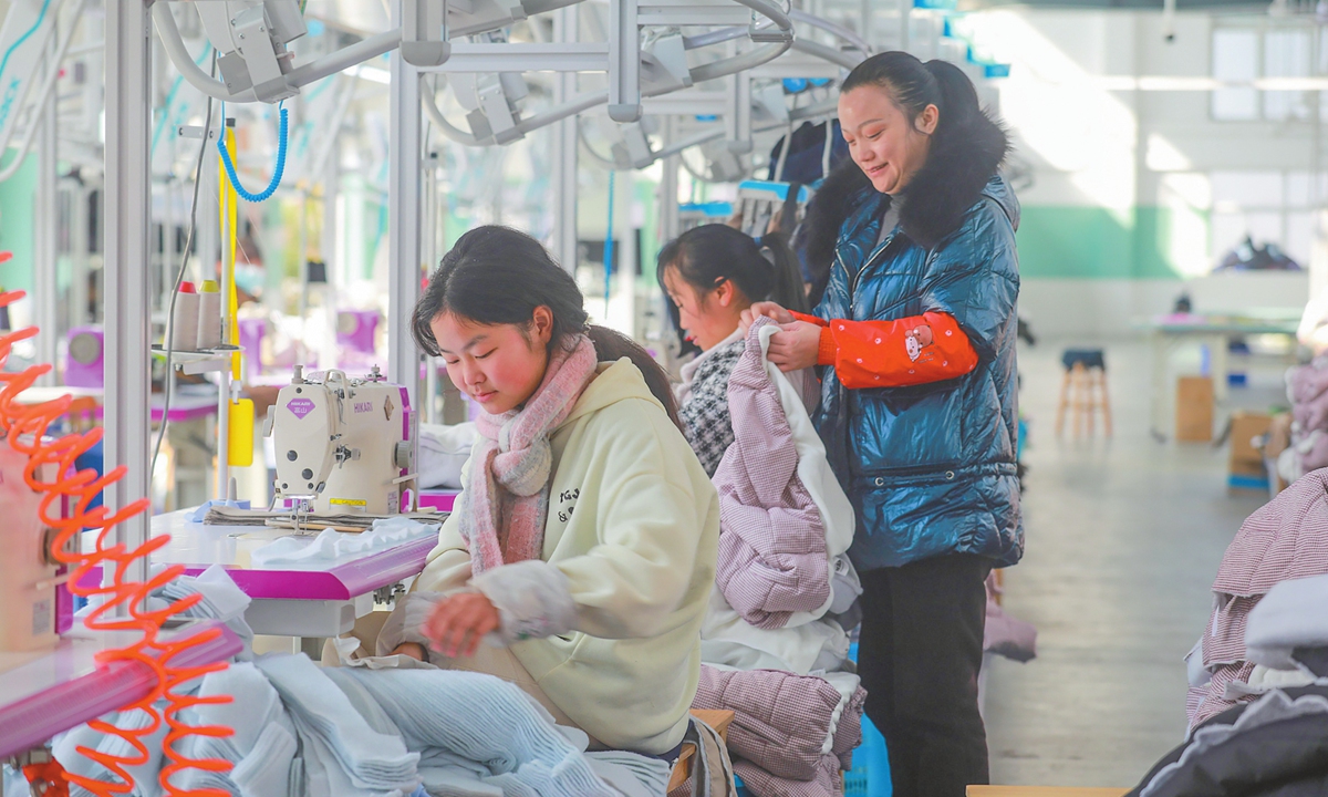 Workers produce made-to-order garments at a clothing factory in an industrial park in Qianxi, Southwest China's Guizhou Province, on November 26, 2025. The province has been creating flexible, nearby job opportunities for rural residents to boost incomes and advance rural revitalization. Photo: VCG