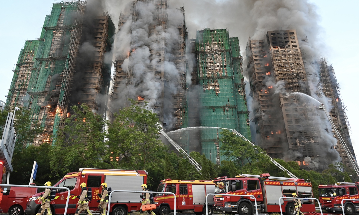 Local firefighters work to put out a huge fire that engulfs a residential area in the Tai Po area of the Hong Kong Special Administrative Region (HKSAR) on November 26, 2025. At least 36 people were killed by the accident and due to the fierce blaze, the Fire Services Department of the HKSAR government raised the alert to No.5 alarm. Photo: VCG