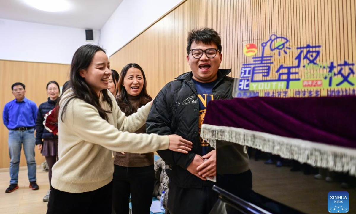 A teacher (L, front) instructs a citizen during a night-time singing class held at the youth activity center in Jiangbei District of Ningbo, east China's Zhejiang Province, Nov. 26, 2025. Starting from 2024, Jiangbei District in Ningbo has integrated educational and training resources from universities, hospitals, law firms and other enterprises and institutions in a night-time school project, offering courses in foreign languages, dance, music and fashion design, among others. It has enrolled more than 9,600 citizens by now. (Xinhua/Jiang Han)