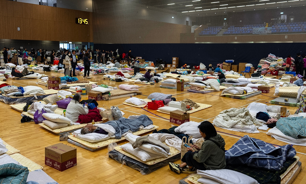 Residents rest at a temporary shelter near the fire scene at Wang Fuk Court on November 27, 2025. Photo: VCG