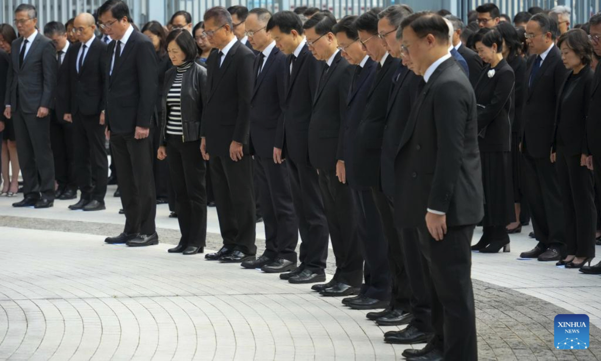 John Lee, chief executive of the Hong Kong Special Administrative Region (HKSAR), together with principal officials of the HKSAR government and civil servants, participates in a memorial service at the government headquarters, paying tribute to the victims of the residential building fire in Tai Po, in Hong Kong, south China, Nov. 29, 2025. The national flag and the HKSAR flag were flown at half-mast at all government buildings. (Xinhua/Zhu Wei)