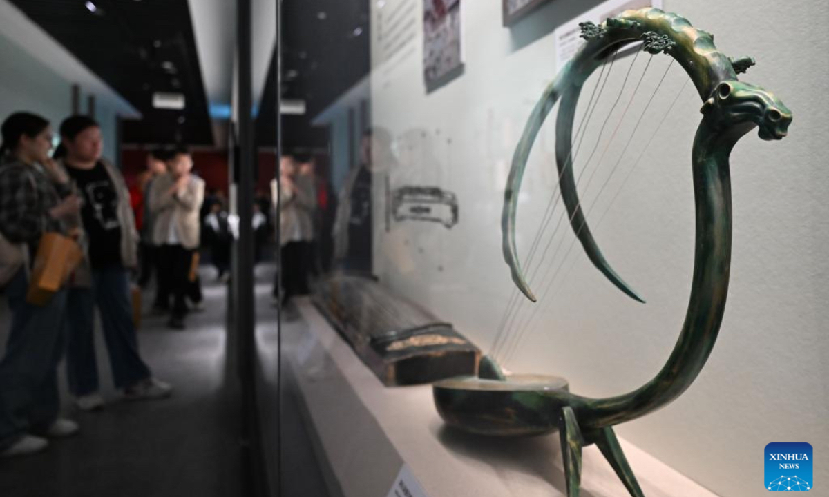 Visitors look at musical instruments during an exhibition themed on various music cultures along the ancient Silk Road at Guangzhou Maritime Museum in Guangzhou, south China's Guangdong Province, Nov. 29, 2025. The exhibition kicked off here on Saturday, showcasing 143 ancient musical instruments from countries along the Silk Road. The exhibition, which will run until April 6, 2026, presents the historical context and artistic integration of musical instruments in the cultural exchanges between the East and the West. (Xinhua/Deng Hua)