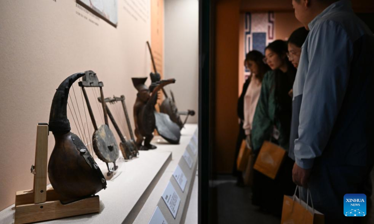 Visitors look at musical instruments during an exhibition themed on various music cultures along the ancient Silk Road at Guangzhou Maritime Museum in Guangzhou, south China's Guangdong Province, Nov. 29, 2025. The exhibition kicked off here on Saturday, showcasing 143 ancient musical instruments from countries along the Silk Road. The exhibition, which will run until April 6, 2026, presents the historical context and artistic integration of musical instruments in the cultural exchanges between the East and the West. (Xinhua/Deng Hua)