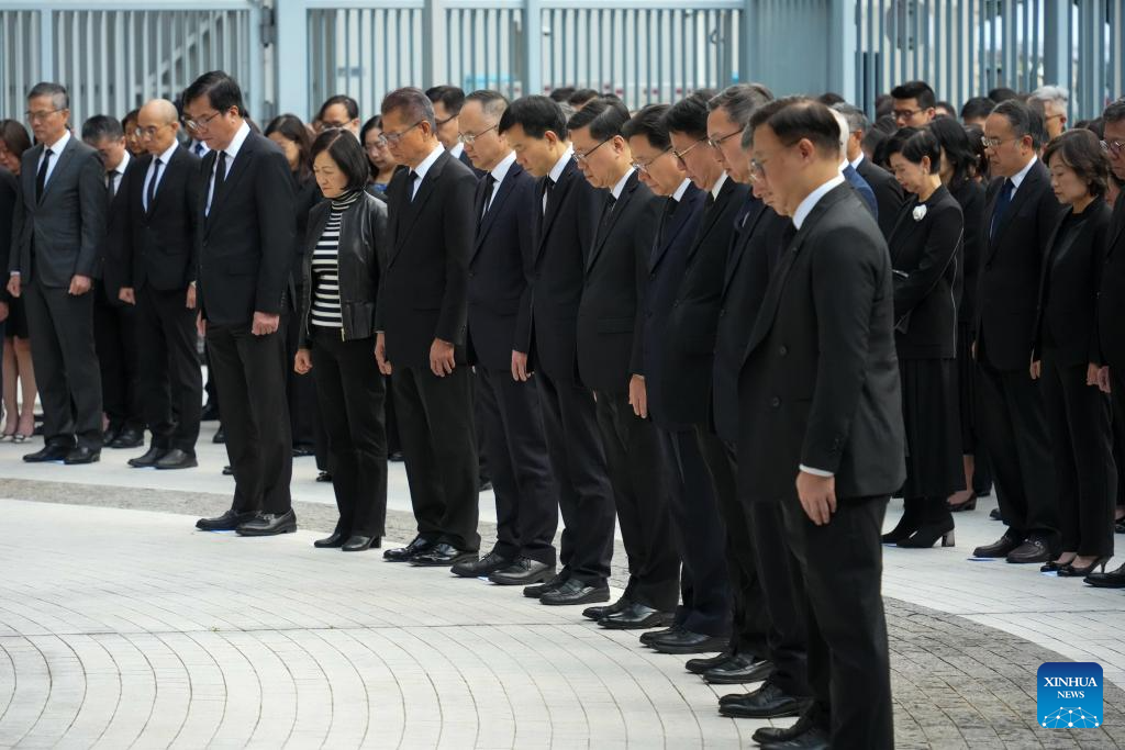 John Lee, chief executive of the Hong Kong Special Administrative Region (HKSAR), together with principal officials of the HKSAR government and civil servants, participates in a memorial service at the government headquarters, paying tribute to the victims of the residential building fire in Tai Po, in Hong Kong, south China, Nov. 29, 2025. The national flag and the HKSAR flag were flown at half-mast at all government buildings. (Xinhua/Zhu Wei)