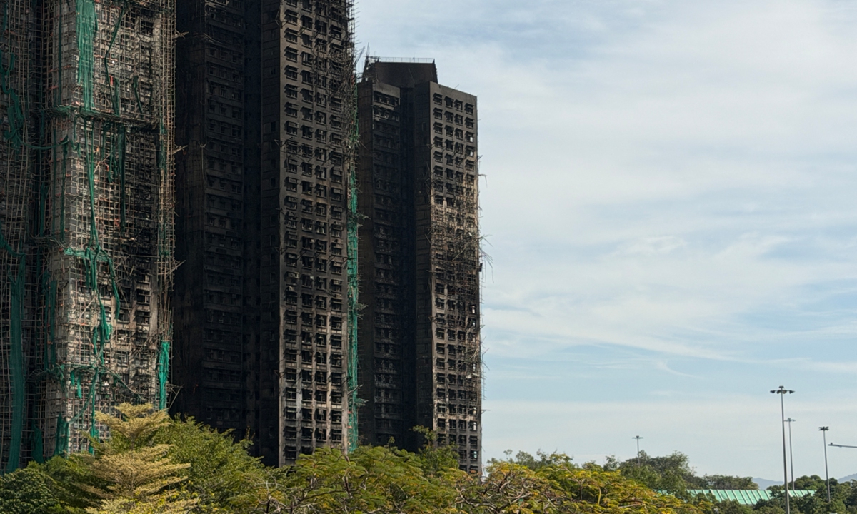 The fire at Wang Fuk Court residential compound in Tai Po, Hong Kong, on November 28, 2025, has been brought under control, with most of the building's exterior blackened by smoke. Photo: VCG