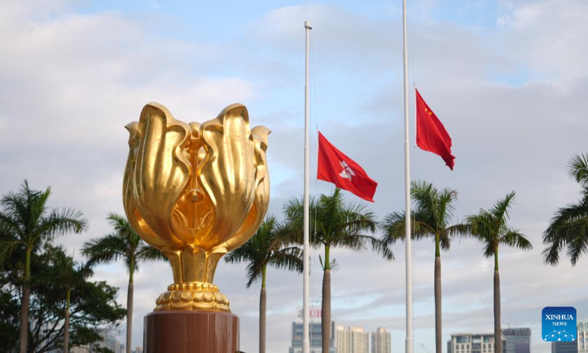 A memorial service is held for victims of the residential building fire in Hong Kong, south China, Nov. 29, 2025. The national flag and the Hong Kong Special Administrative Region flag were flown at half-mast at all government buildings. (Xinhua/Lui Siu Wai)