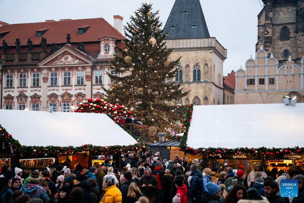 People visit a Christmas market in Prague, the Czech Republic, Nov. 29, 2025. The Christmas market in Prague's Old Town officially opened on Saturday, attracting large numbers of residents and tourists. (Photo by Dana Kesnerova/Xinhua)