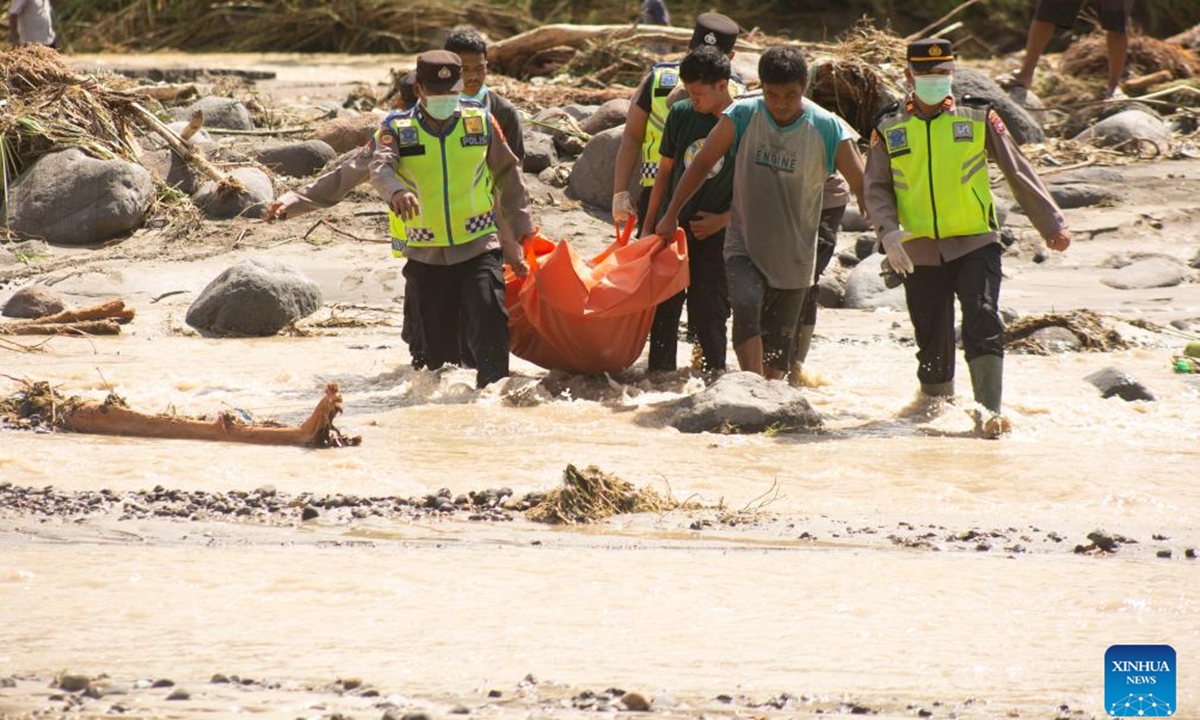 Rescuers cross a river to transfer a victim's body during a search operation after floods and landslides hit Padang Pariaman Regency, West Sumatra, Indonesia, Nov. 29, 2025. A total of 303 people died and 279 remain missing after flash floods and landslides struck three provinces in Indonesia's Sumatra region, the country's National Disaster Management Agency (BNPB) said on Saturday. (Photo by Andri Mardiansyah/Xinhua)