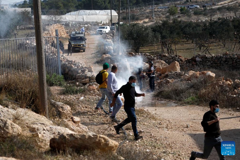 Palestinians take shelter from tear gases fired by Israeli forces in the village of Tarqumiyah, west of Hebron in the West Bank, on Nov. 28, 2025.

Israeli security forces and settlers have killed 1,030 Palestinians in the occupied West Bank, including East Jerusalem, since Oct. 7, 2023, the United Nations Office of the High Commissioner for Human Rights (OHCHR) has verified, a UN spokesperson said here Friday.

Among the fatalities were 223 children, Jeremy Laurence, spokesperson for the OHCHR, told a regular UN press briefing in Geneva. (Photo by Mamoun Wazwaz/Xinhua)