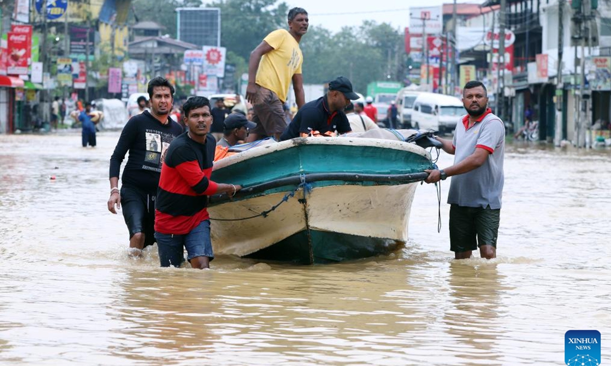 People evacuate by boat in floodwater after heavy rains on the outskirts of Colombo, Sri Lanka, on Nov. 29, 2025. Sri Lankan President Anura Kumara Dissanayake has declared a State of Public Emergency effective on Friday, as the country confronts one of its worst weather-related disasters in recent years. (Photo by Ajith Perera/Xinhua)
