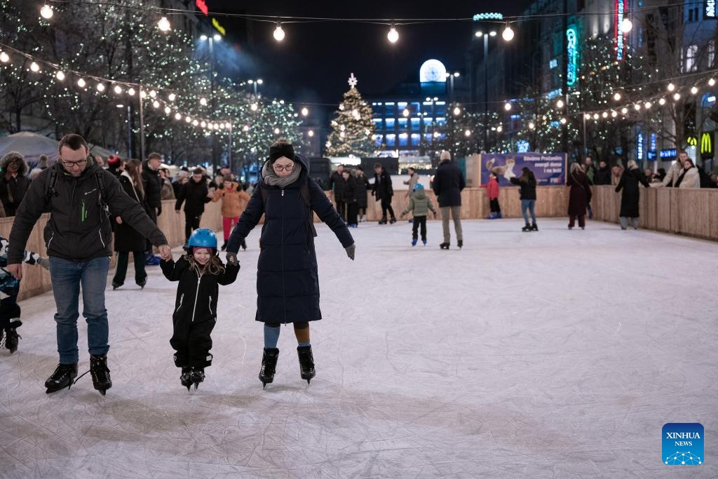 People skate at a Christmas market in Prague, the Czech Republic, Nov. 29, 2025. The Christmas market in Prague's Old Town officially opened on Saturday, attracting large numbers of residents and tourists. (Photo by Dana Kesnerova/Xinhua)