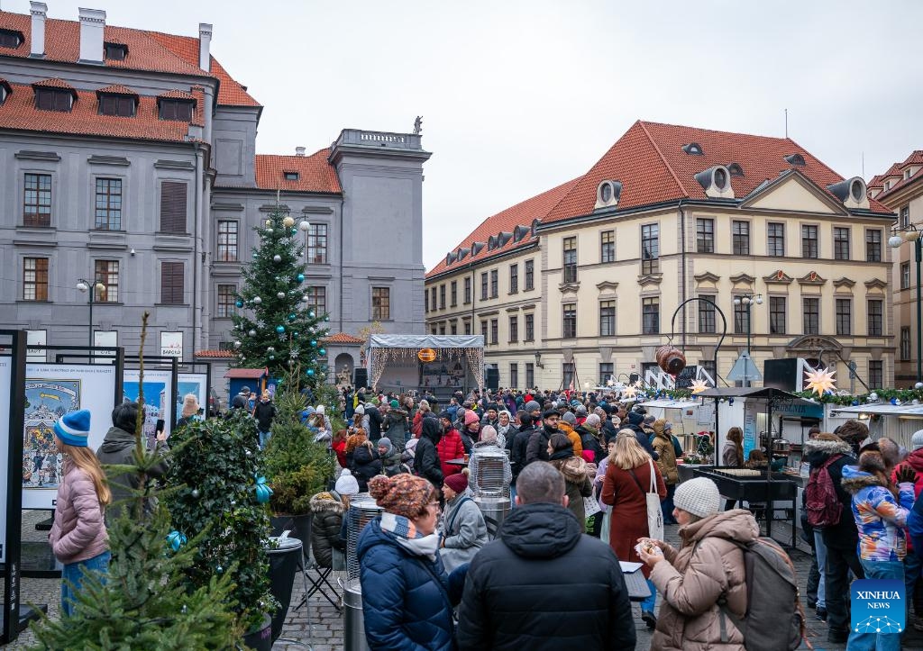People visit a Christmas market in Prague, the Czech Republic, Nov. 29, 2025. The Christmas market in Prague's Old Town officially opened on Saturday, attracting large numbers of residents and tourists. (Photo by Dana Kesnerova/Xinhua)