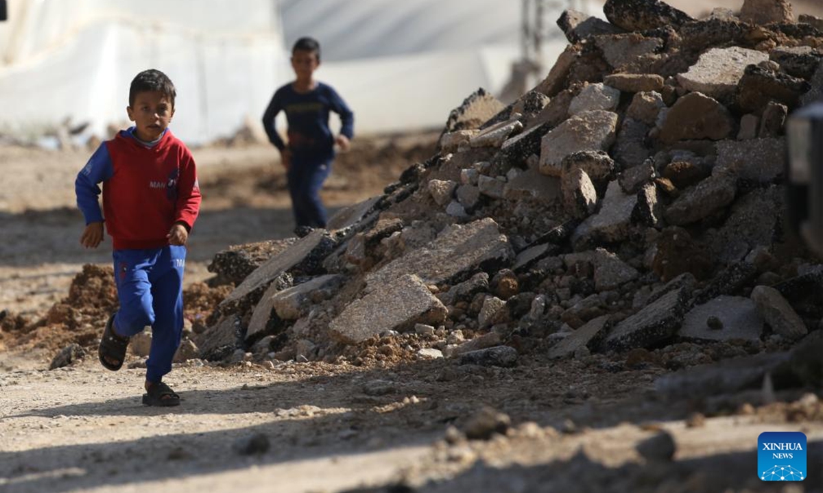 Two children run along a destroyed street in the town of Tammun, south of Tubas in the West Bank, on Nov. 28, 2025. Israeli security forces and settlers have killed 1,030 Palestinians in the occupied West Bank, including East Jerusalem, since Oct. 7, 2023, the United Nations Office of the High Commissioner for Human Rights (OHCHR) has verified, a UN spokesperson said here Friday. Among the fatalities were 223 children, Jeremy Laurence, spokesperson for the OHCHR, told a regular UN press briefing in Geneva. (Photo by Nidal Eshtayeh/Xinhua)