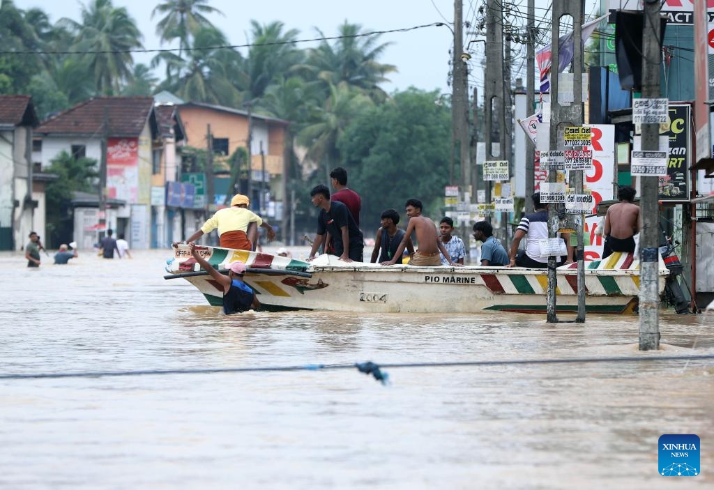 People evacuate by boat in floodwater after heavy rains on the outskirts of Colombo, Sri Lanka, on Nov. 29, 2025. Sri Lankan President Anura Kumara Dissanayake has declared a State of Public Emergency effective on Friday, as the country confronts one of its worst weather-related disasters in recent years. (Photo by Ajith Perera/Xinhua)
