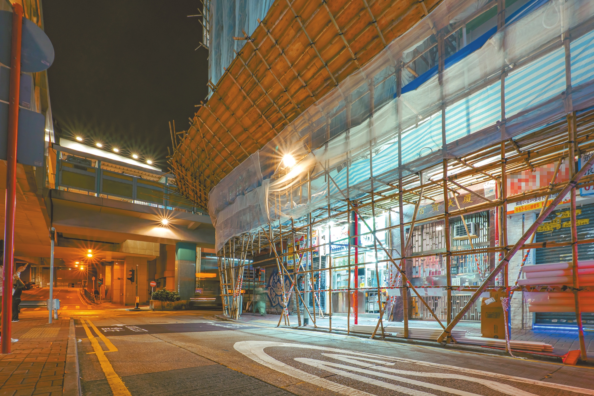 Bamboo construction scaffolding lining a street in Mong Kok, Yau Tsim Mong district, HKSAR