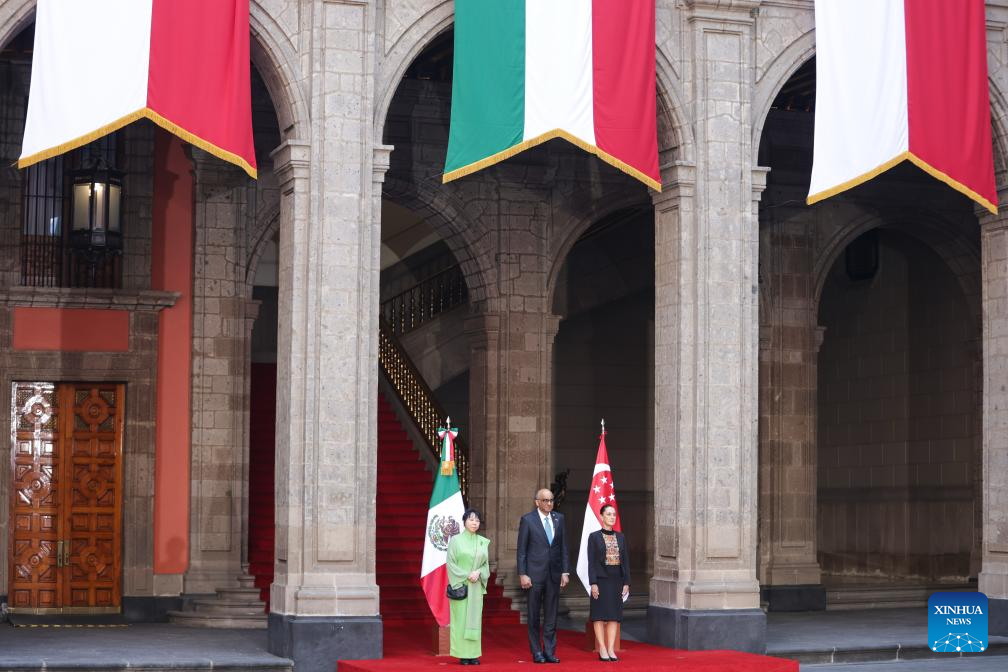 Mexican President Claudia Sheinbaum (R) hosts a welcome ceremony for visiting Singaporean President Tharman Shanmugaratnam (C) at the National Palace in Mexico City, Mexico, on Dec. 1, 2025. (Photo by Francisco Canedo/Xinhua)