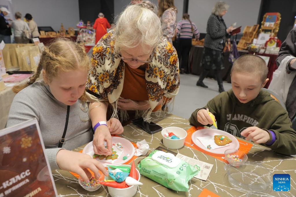 Children experience making gingerbread cookies during the 10th Gingerbread World International Art Festival in St. Petersburg, Russia, Nov. 30, 2025. (Photo by Irina Motina/Xinhua)