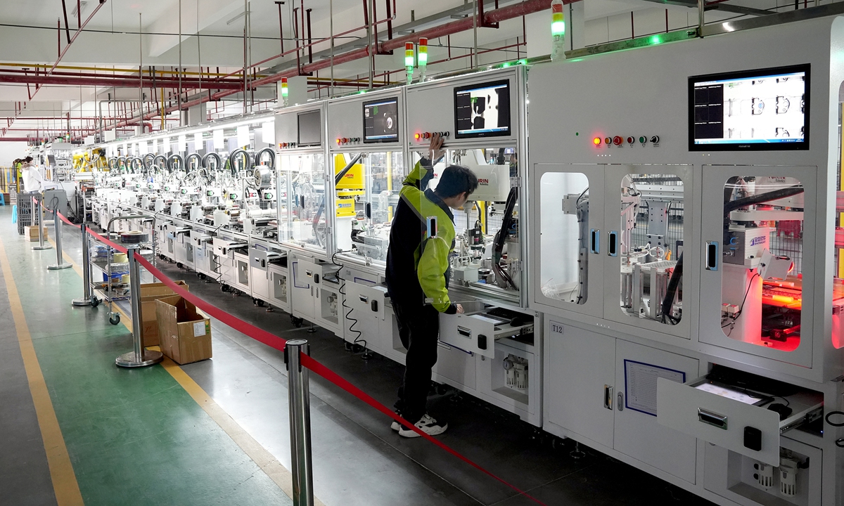 A worker operates automated equipment on the production line at a high-tech manufacturing company in Huaying, Southwest China's Sichuan Province, on December 1, 2025. In recent years, the city has advanced toward high-end, smart and green development, and steadily upgraded industrial equipment and technologies.